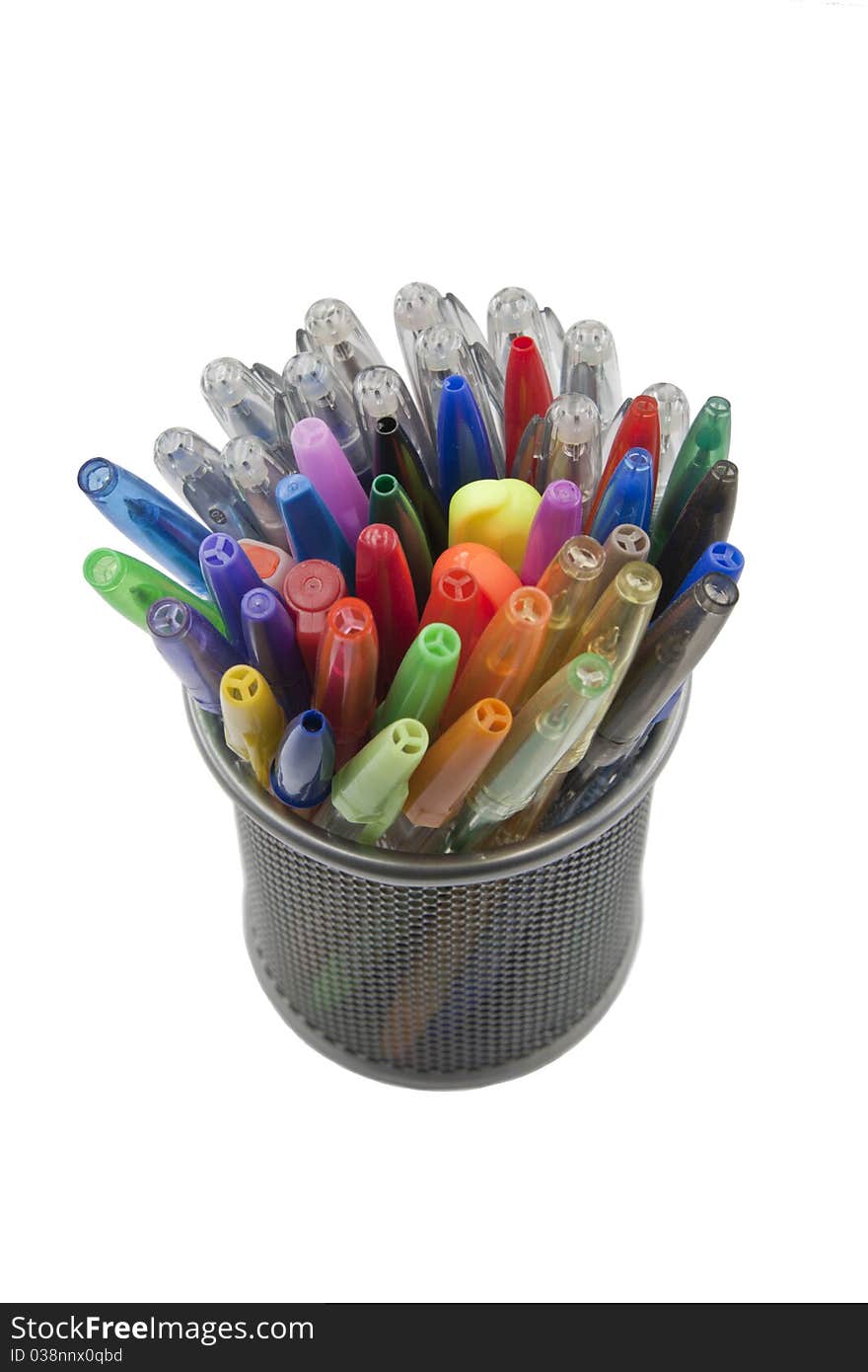 Colored pens in the pen holder, isolated on white