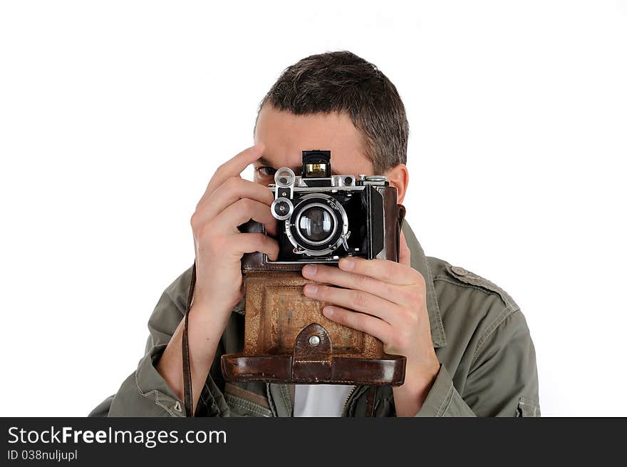 Young professional photographer with old retro film camera. isolated on white background