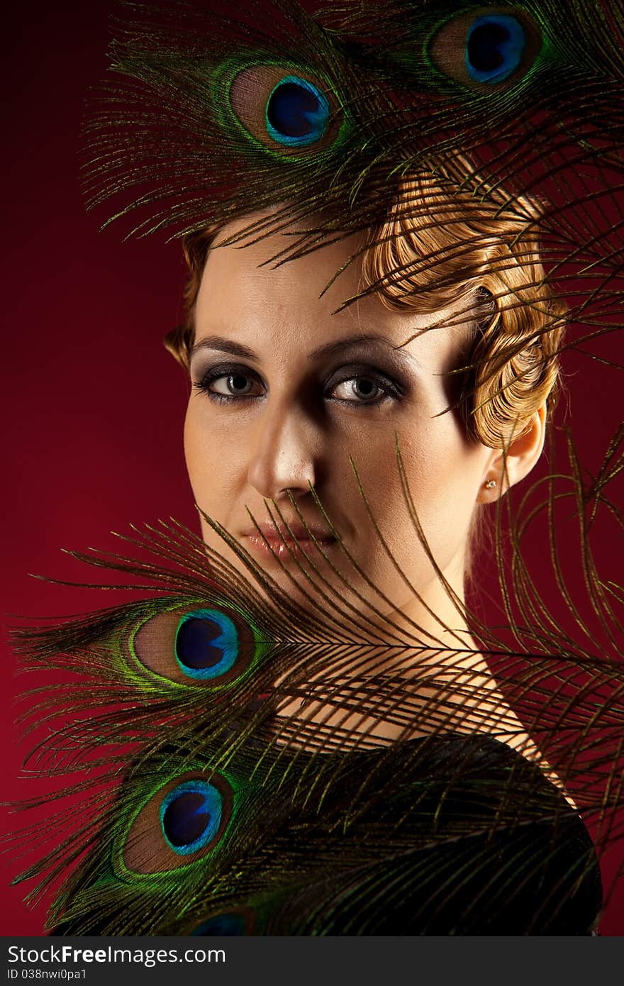 Vertical portrait of elegant woman with feather