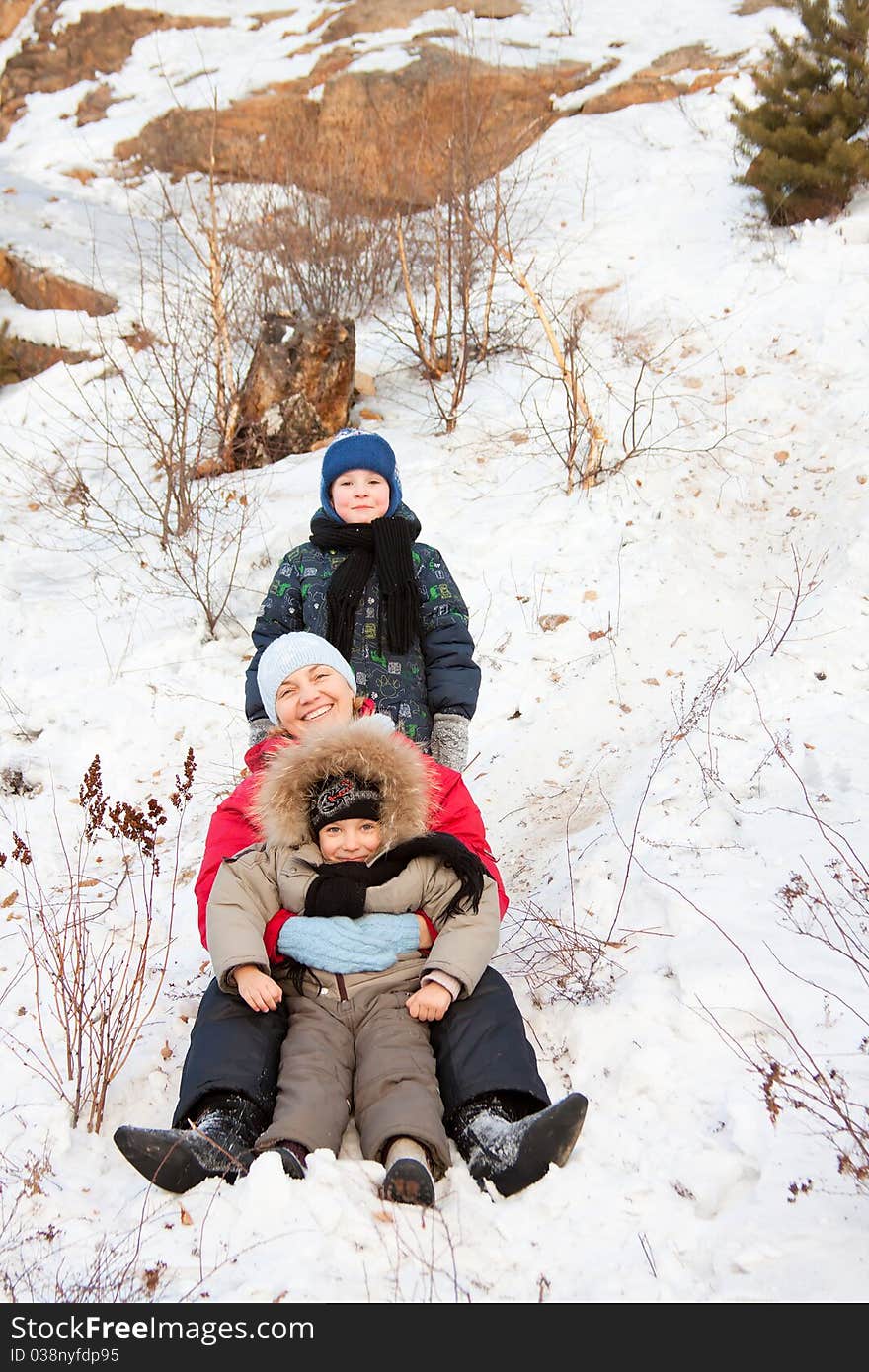 Mother and two sons playing in winter park. Mother and two sons playing in winter park