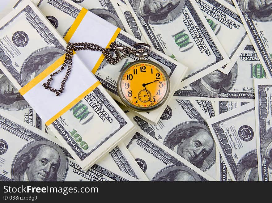 Pocket watch on a stack of dollars, reflecting time and money