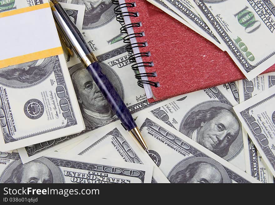 Dollars, notebook and pen, money background