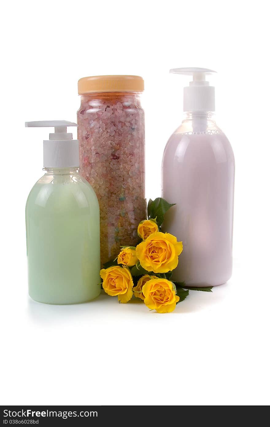 Bottles with liquid soap and sea salt  on a white background