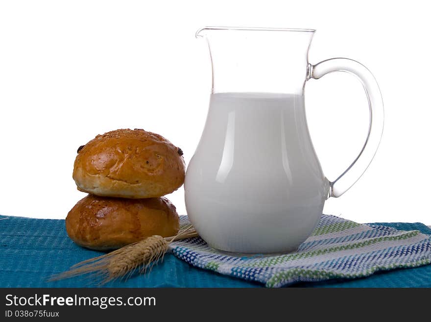 Fresh bread with glass of milk on a white background