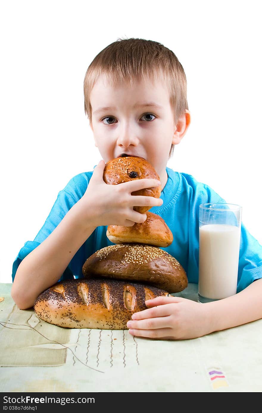 Happy boy eating bread on a white background