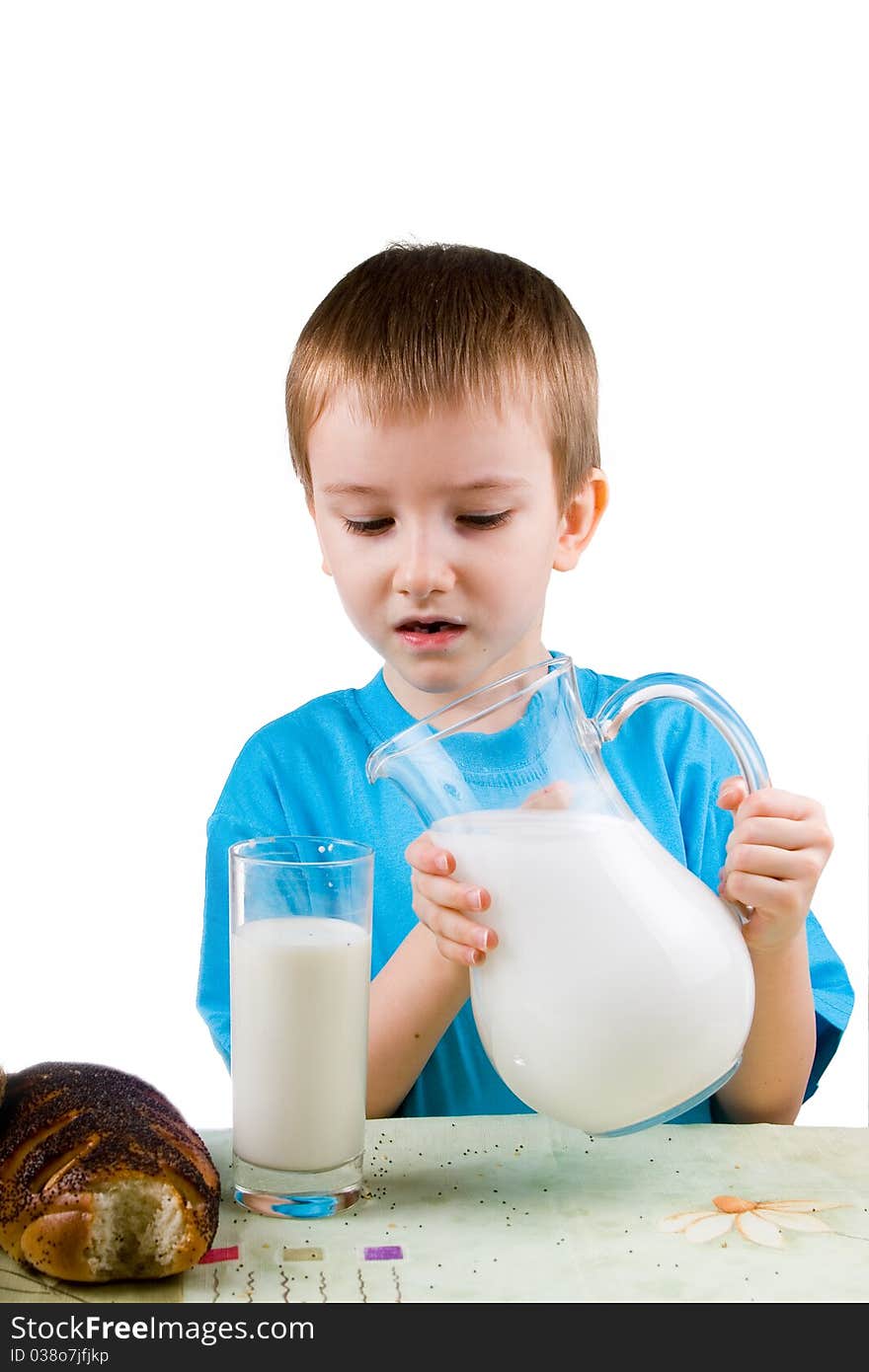 Boy with  a pitcher and a glass of milk on a white background