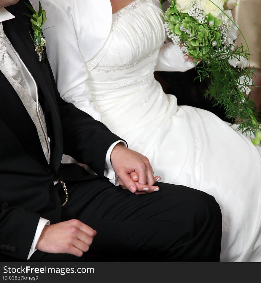 A bridal couple hand in hand