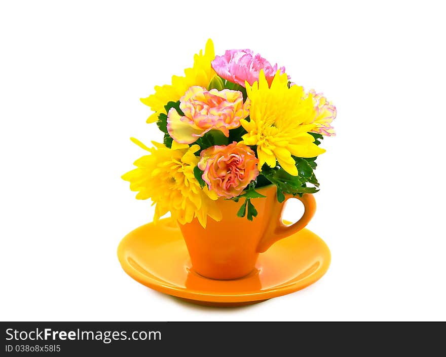 Colorful flowers in the yellow coffee cup.