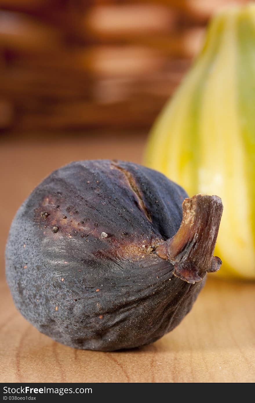 Ripe fruits of a fig on a wooden table.