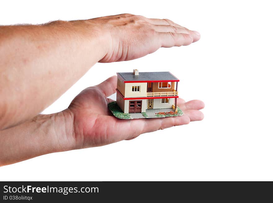 Man protecting miniature house on hand. White background