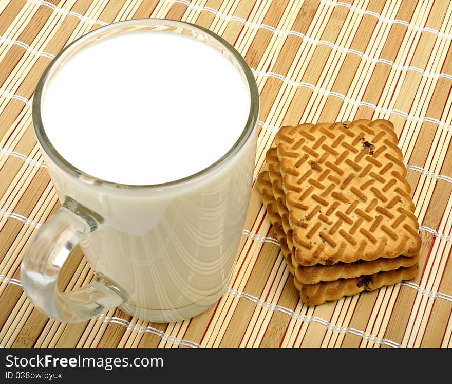 Milk and cookies on a wooden napkin