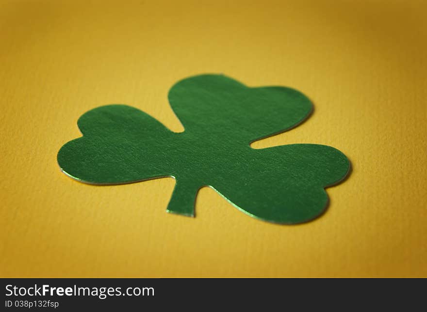 Close up of a shamrock on yellow background