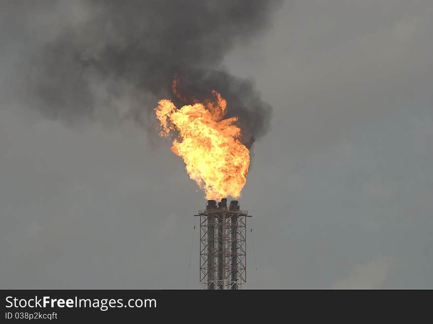 Flaring black gas into the atmosphere. Flaring black gas into the atmosphere