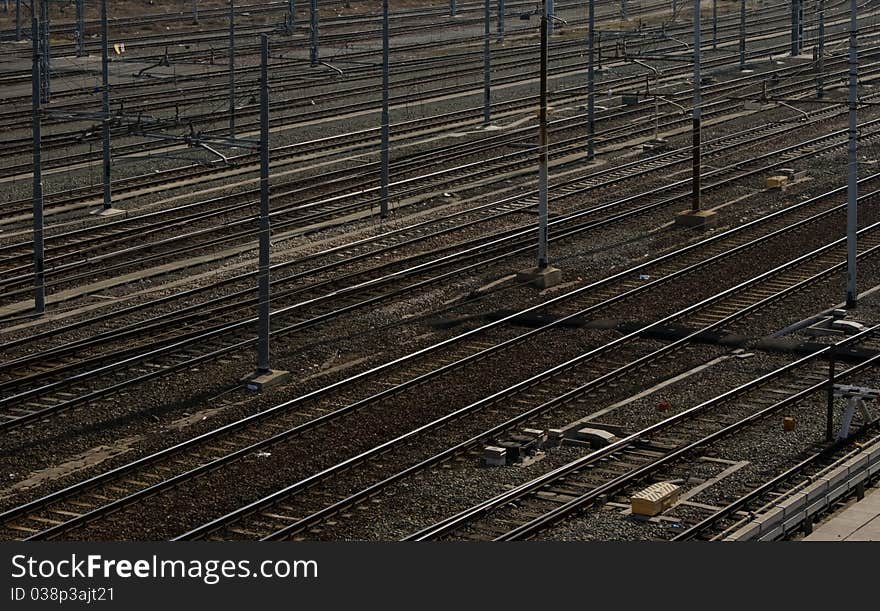 Multiple parallel railroad tracks near to Turin station.