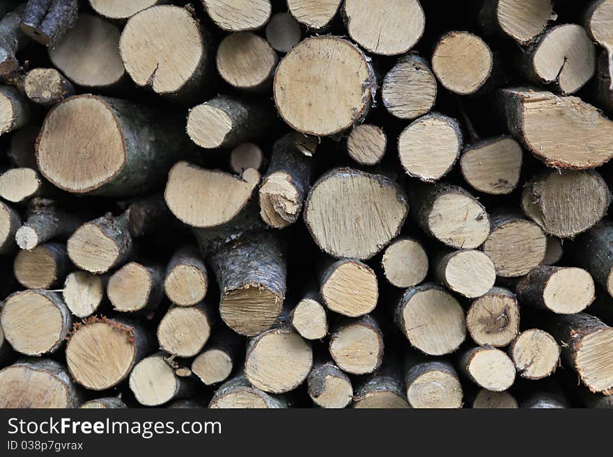 Stocked logs arranged in a row. Stocked logs arranged in a row