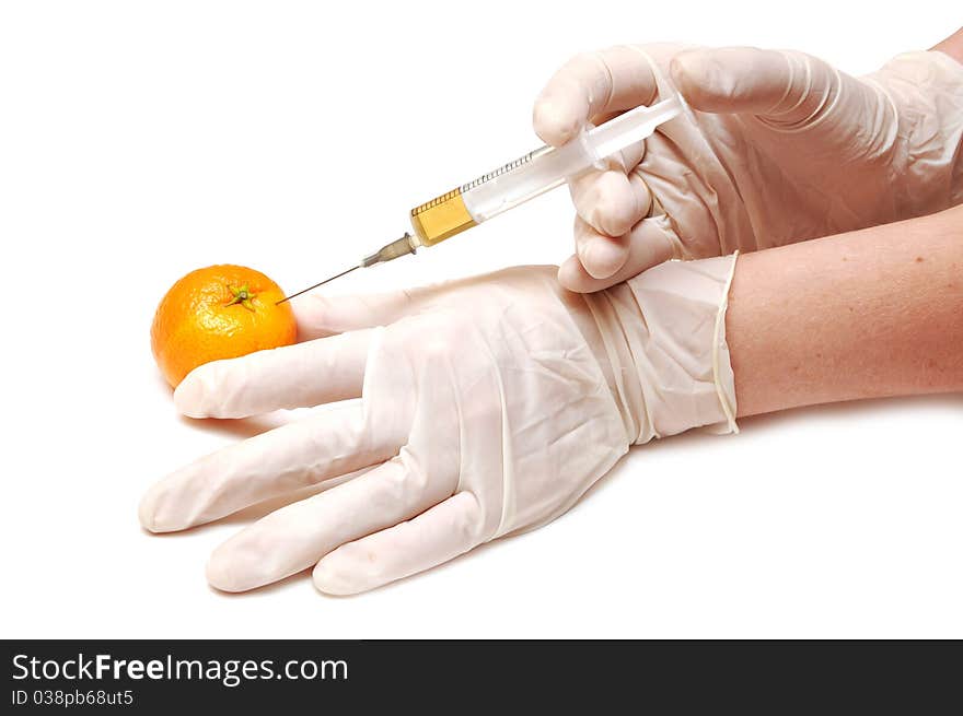 Mandarine gets an orange substance injected from hand with gloves on white