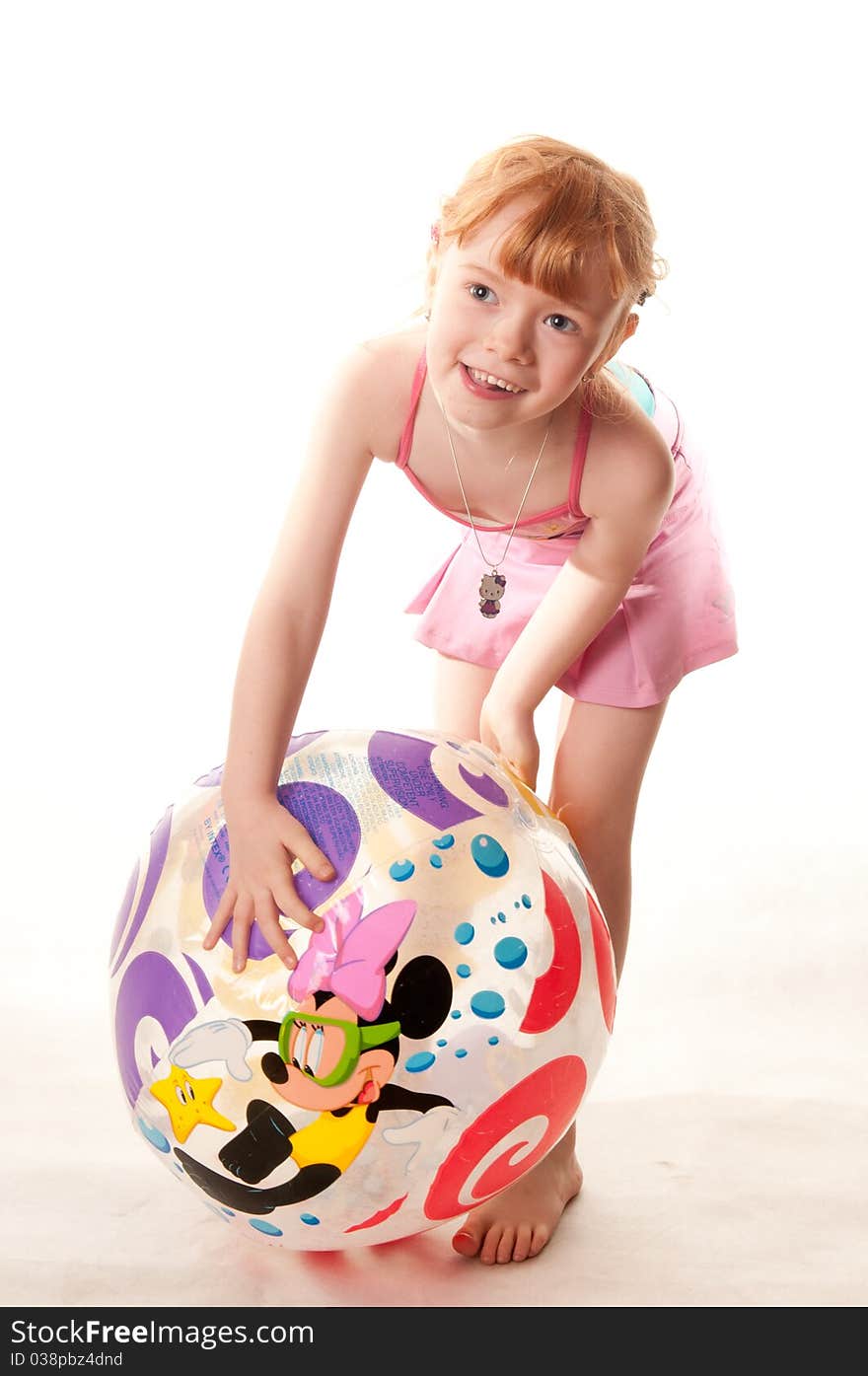 Cute little girl in pink swimsuit