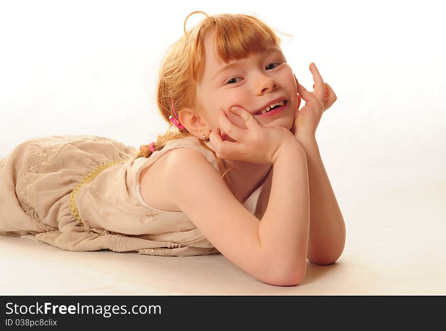 Cute little girl lying on the floor day dreaming. Cute little girl lying on the floor day dreaming