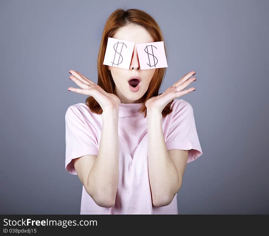 Girl with dollars symbol on eyes. Studio shot.