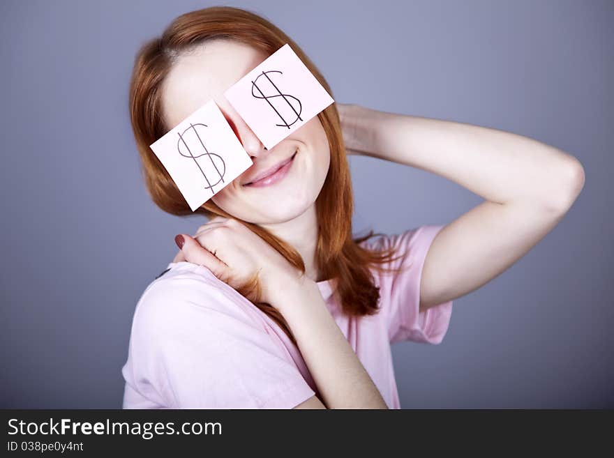 Girl with dollars symbol on eyes. Studio shot.