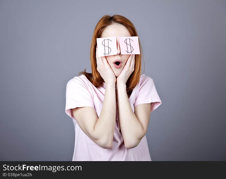 Girl with dollars symbol on eyes. Studio shot.