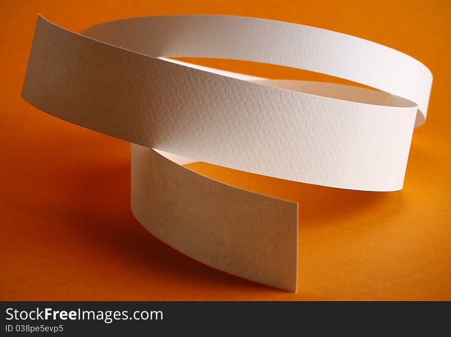 White round paper strips on orange background