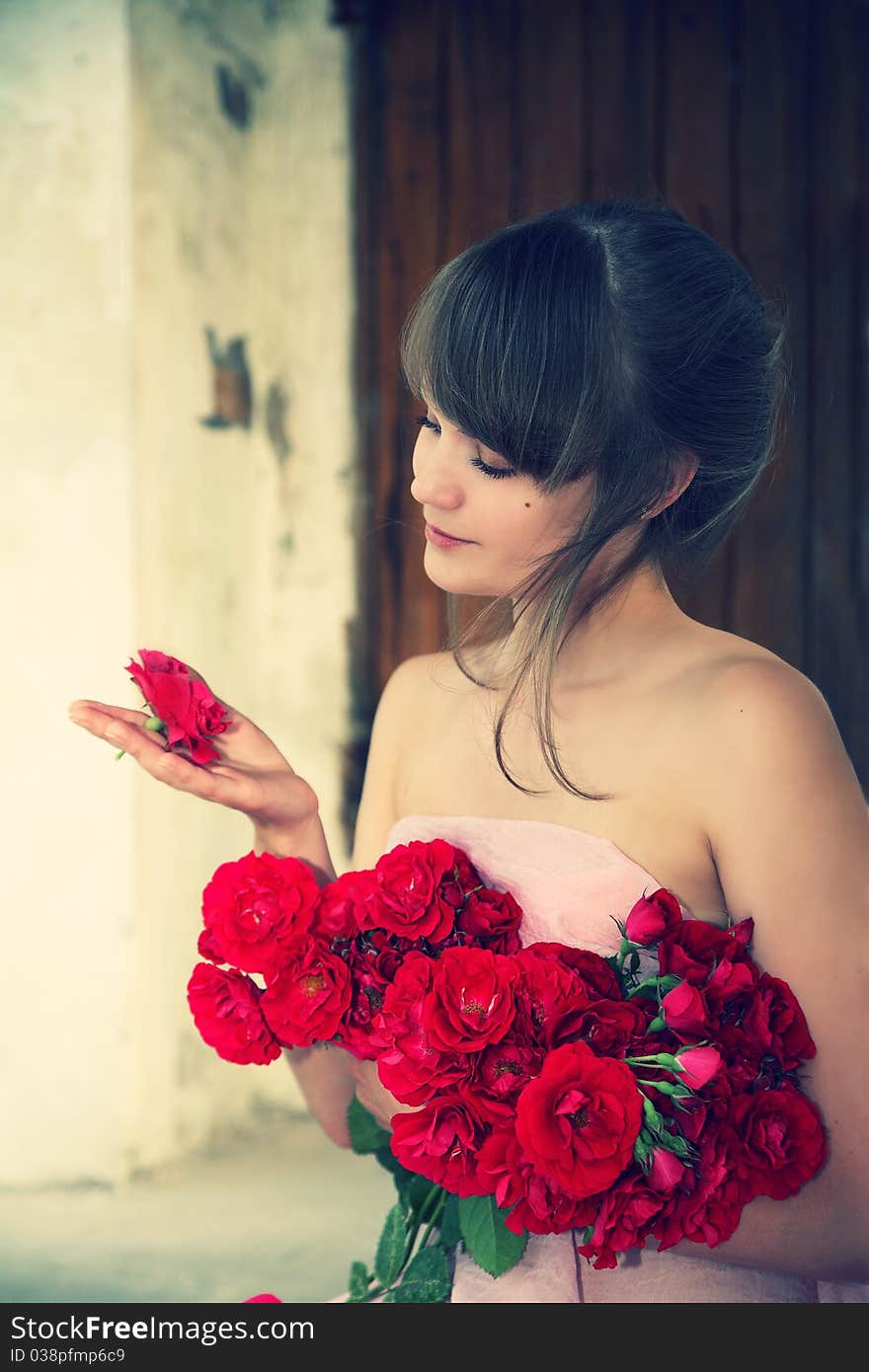 Young beautiful girl with a bouquet from roses