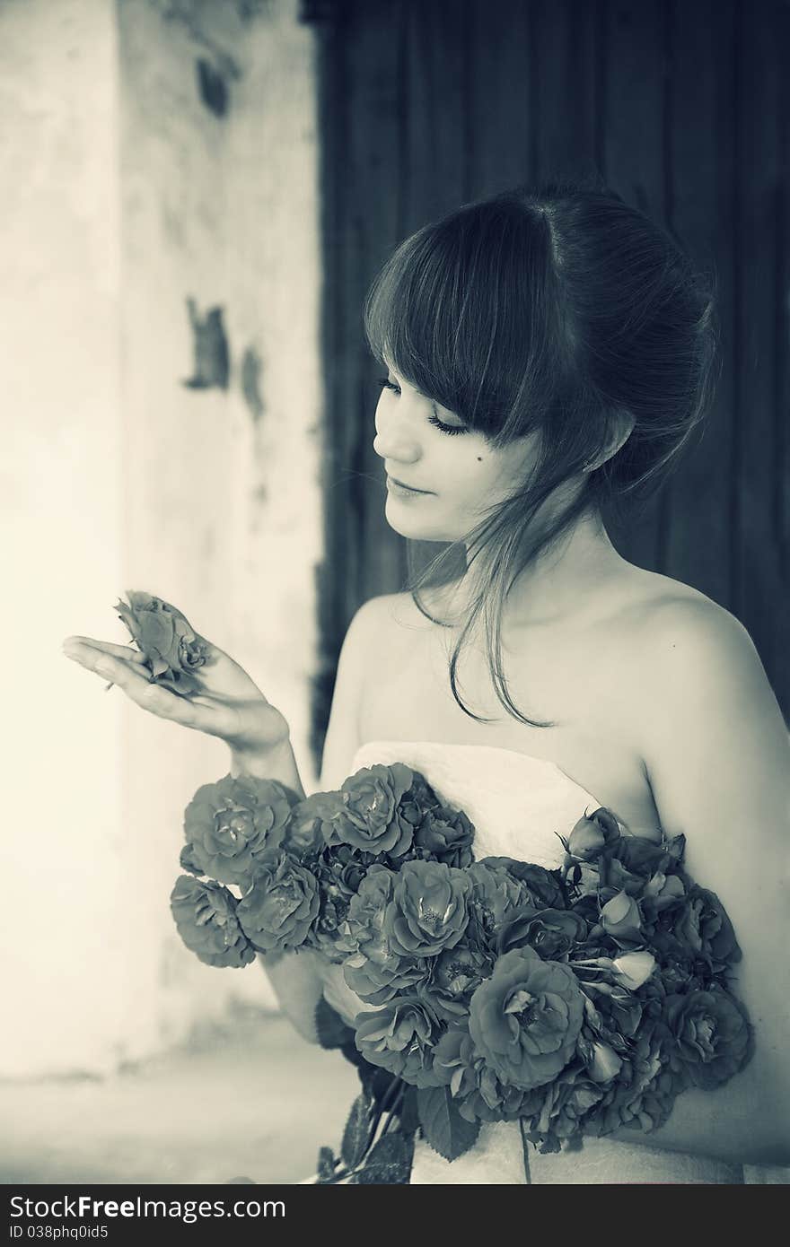 Young beautiful girl with a bouquet from roses