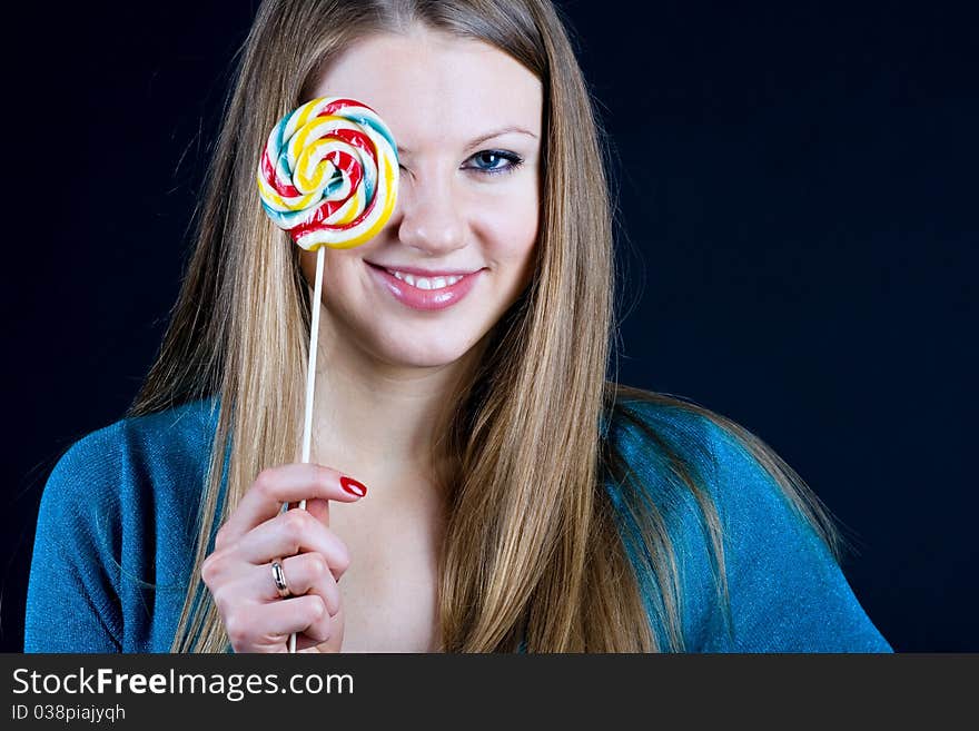 Beautiful girl holding a candy