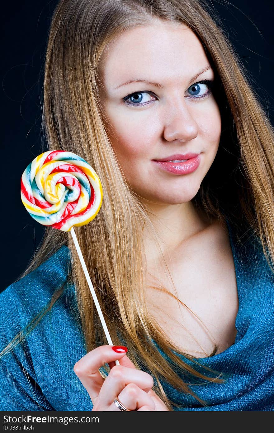 Beautiful girl holding a candy