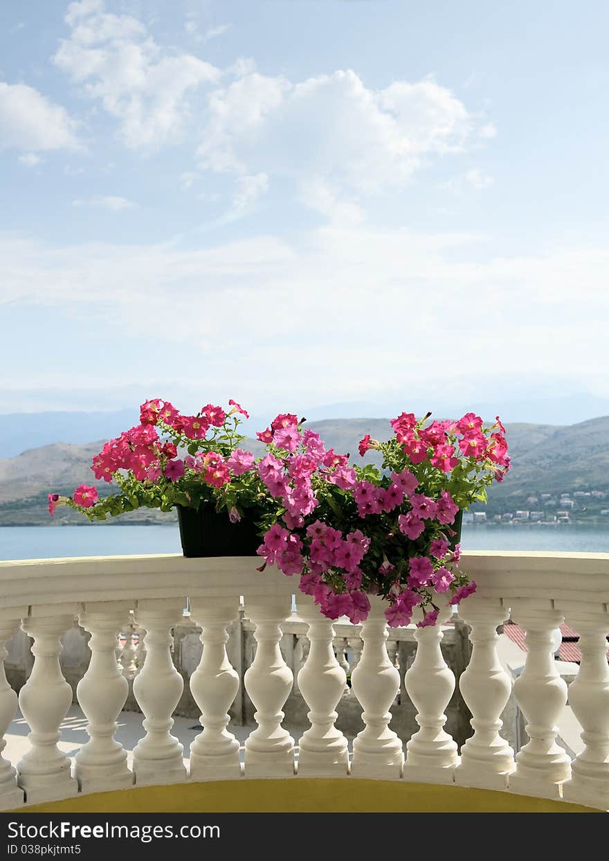 Balcony with flower and view to the bay and mountain. Balcony with flower and view to the bay and mountain