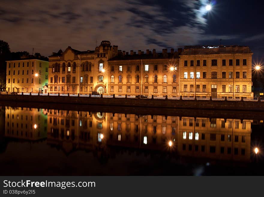 An old Russian building in St. Petersburg with a reflection in the Fontanka river. An old Russian building in St. Petersburg with a reflection in the Fontanka river