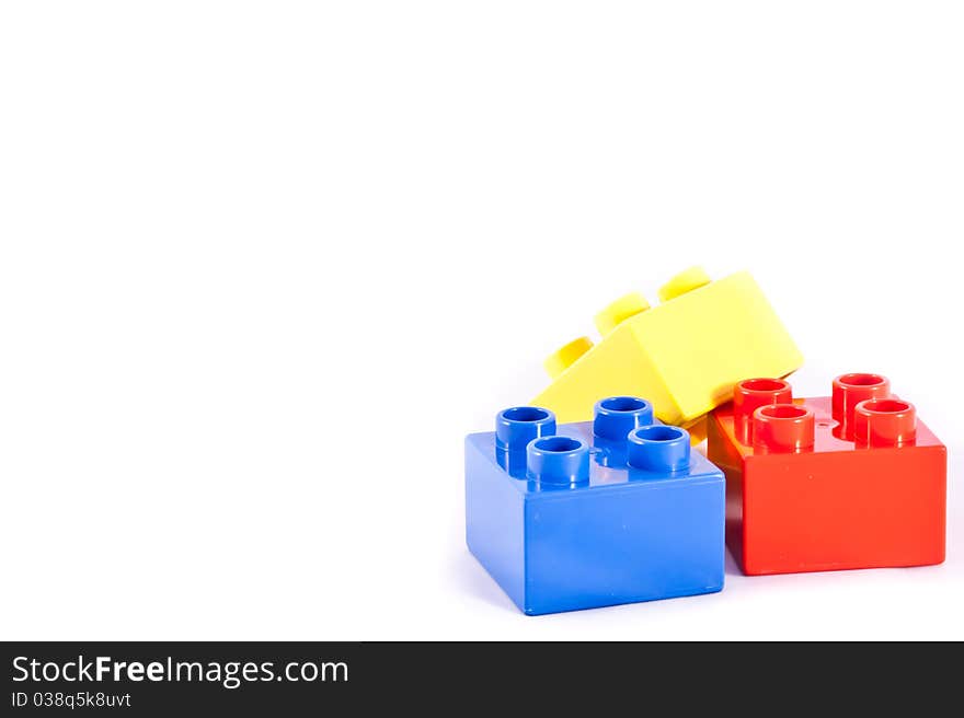 Plastic building blocks on white background. Bright colors.