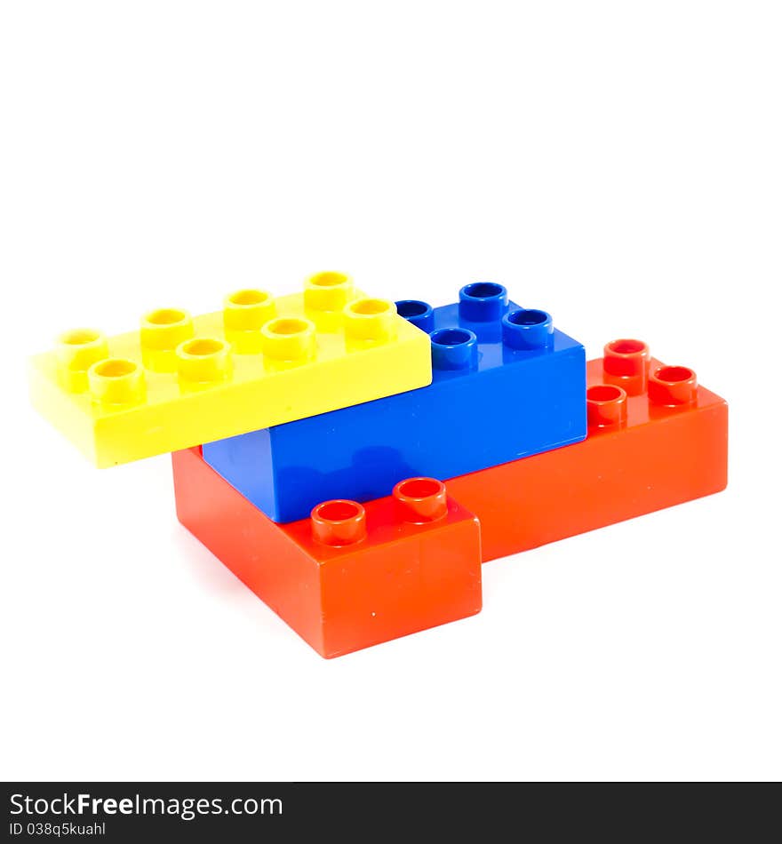 Plastic building blocks on white background. Bright colors.