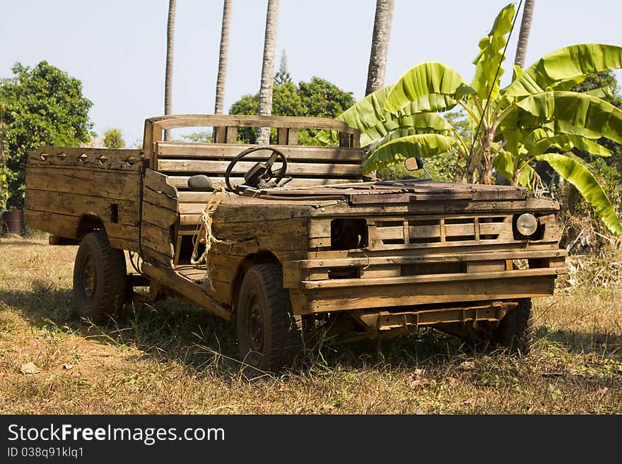 Old wooden car in the jungle . Thailand .