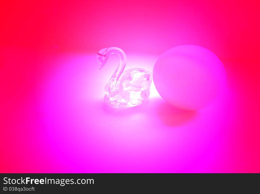 Egg and swan figure in red-pink illumination. Egg and swan figure in red-pink illumination