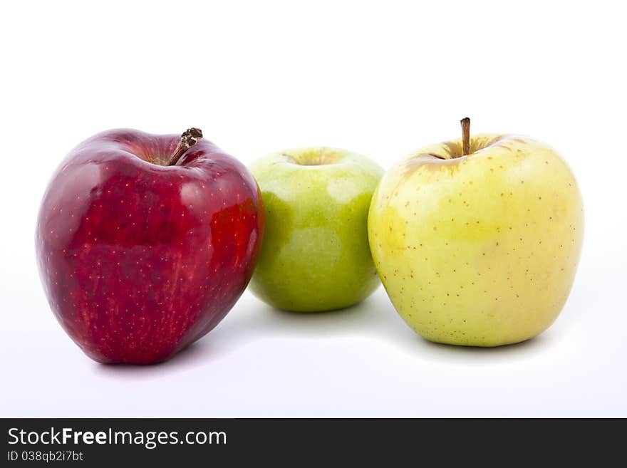 Yellow apple with brown spots on a white background