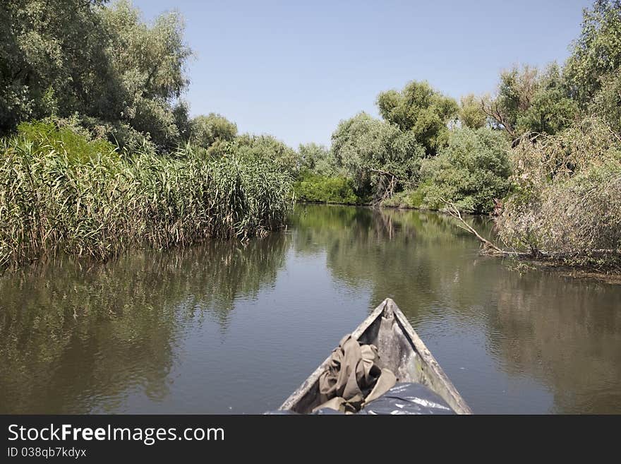 Boat is swiming through delta channel. Boat is swiming through delta channel