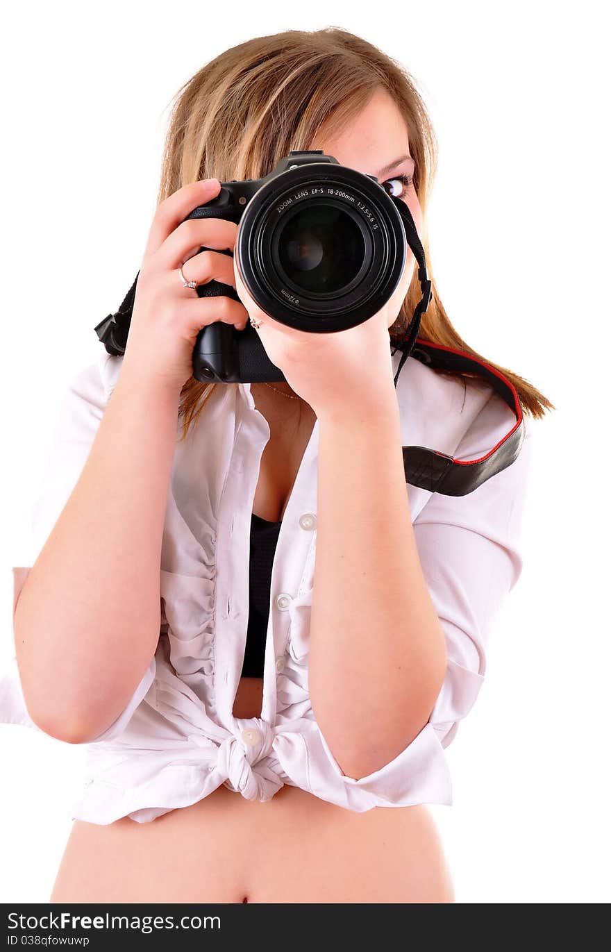 Young woman with photographic camera on white background