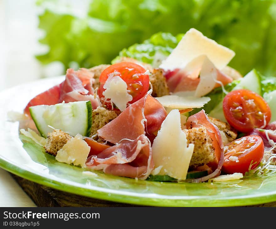 Fresh salad from vegetables, cheese and ham