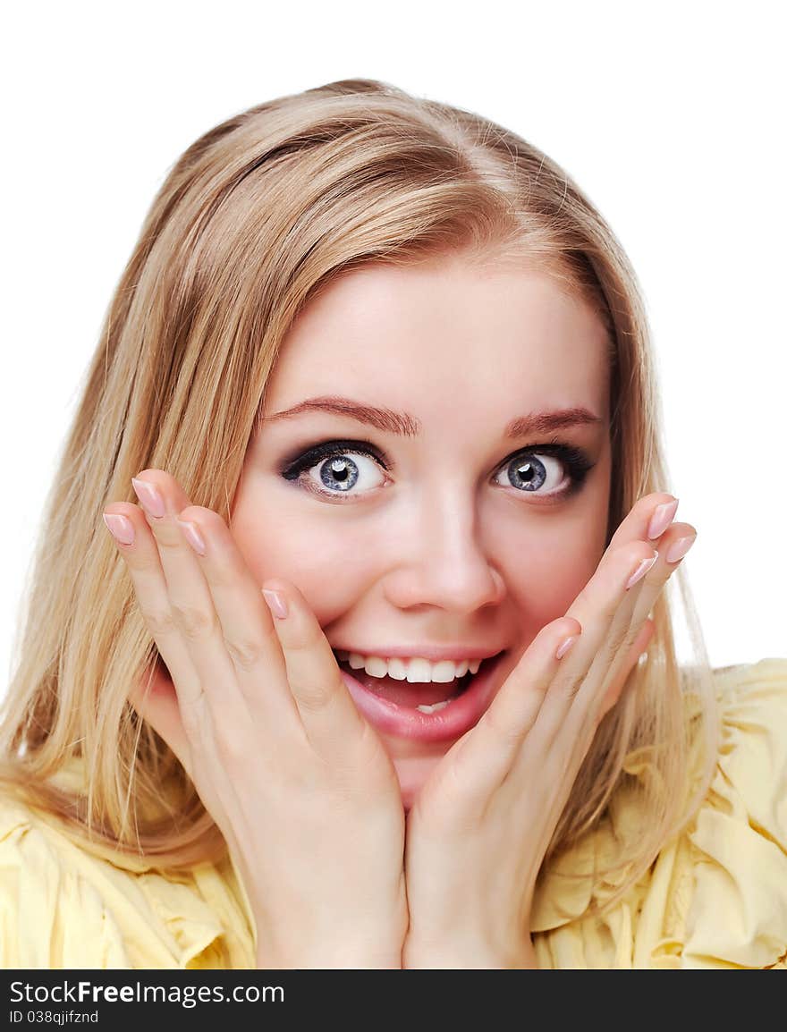 Portrait shot of a beautiful caucasian woman. Holding her face in astonishment.