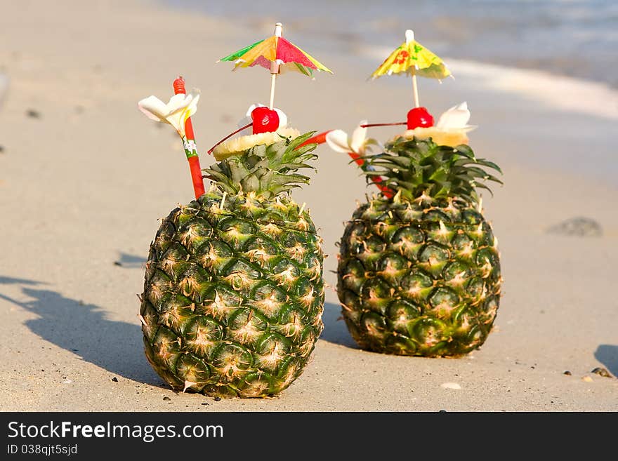 Tropical pineapple cocktail drink at the beach overlooking the ocean