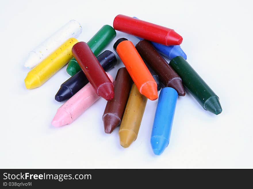 colored crayons spread over white background. colored crayons spread over white background