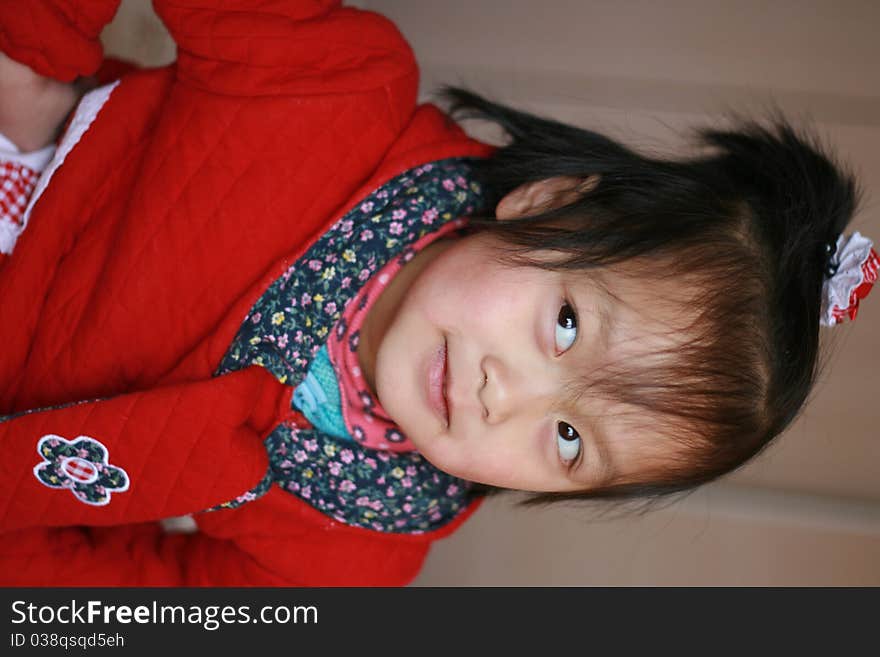 Expressive portrait of young asia child with funny expression on face looking to left of photo. Confused/Uncertain expression or naughty expression. Expressive portrait of young asia child with funny expression on face looking to left of photo. Confused/Uncertain expression or naughty expression