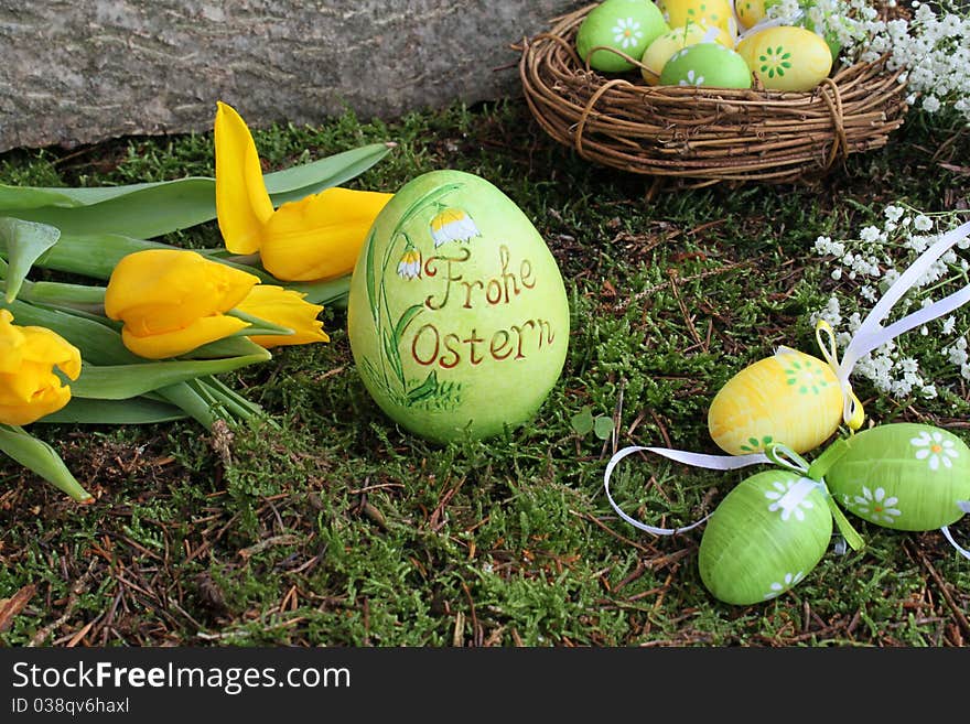 Easter eggs and yellow tulips in the garden