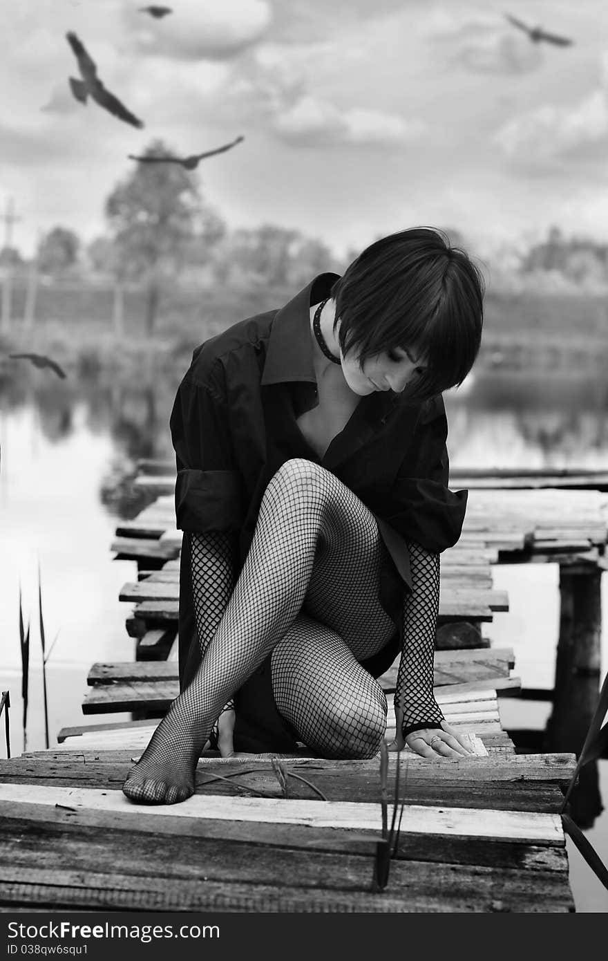 Black and white portrait of beautiful young girl on the river