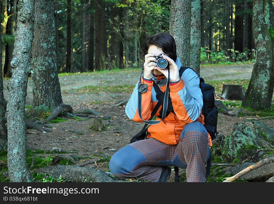 Young girl with camera in forest. Young girl with camera in forest