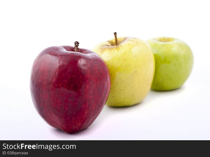 Yellow apple with brown spots on a white background