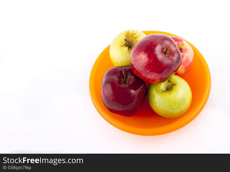 Yellow apple with brown spots on a white background