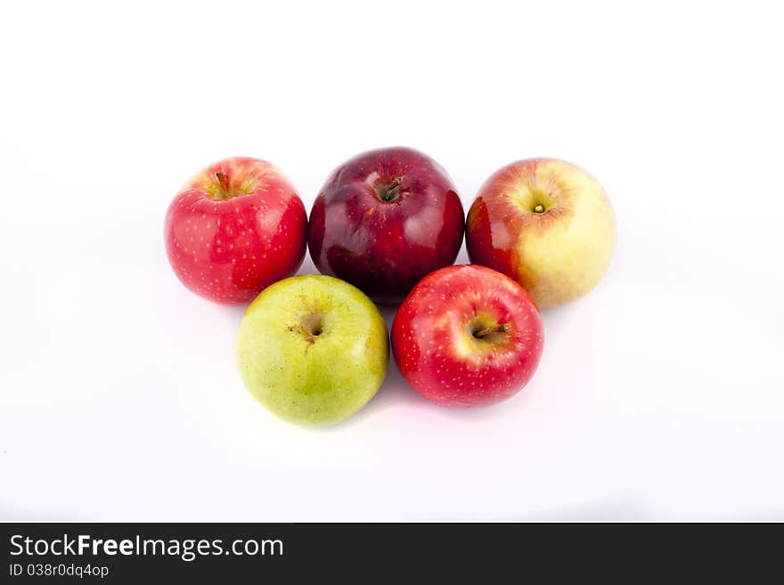 Yellow apple with brown spots on a white background